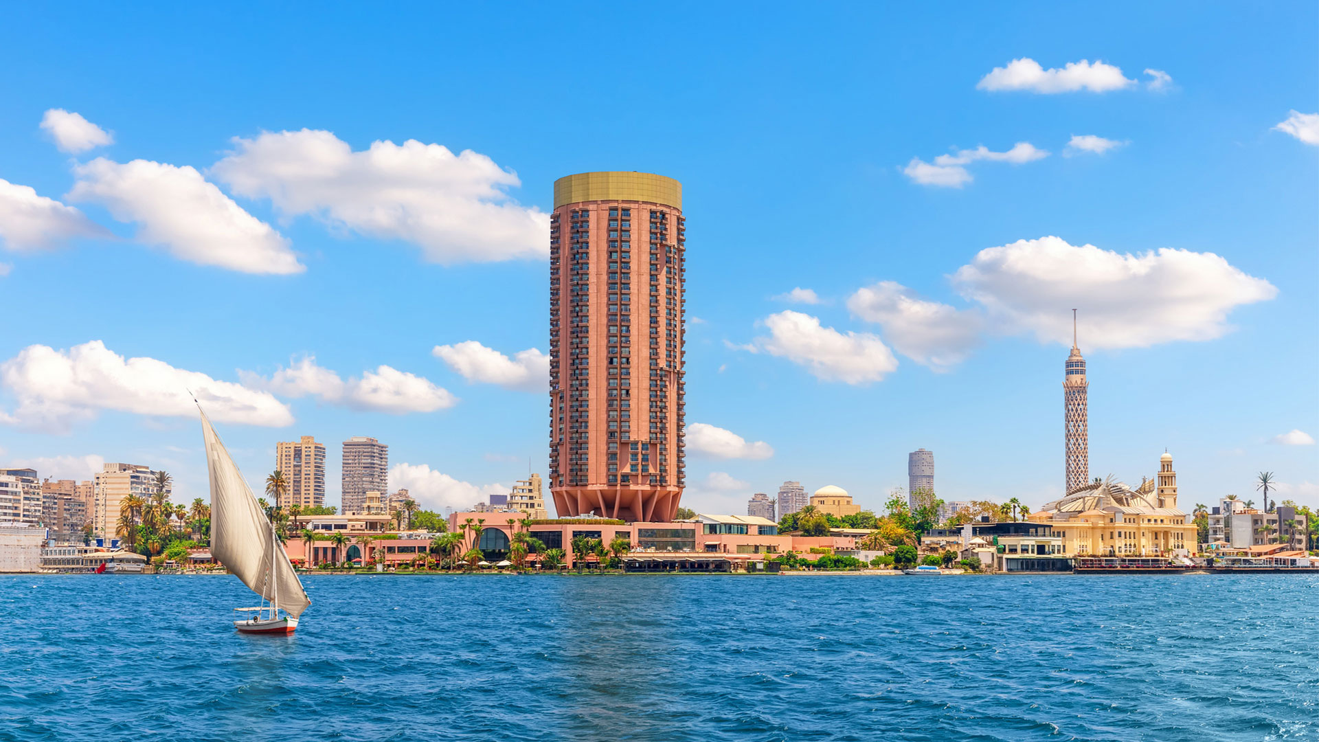 Felucca sailing past the Cairo skyline and Cairo Tower