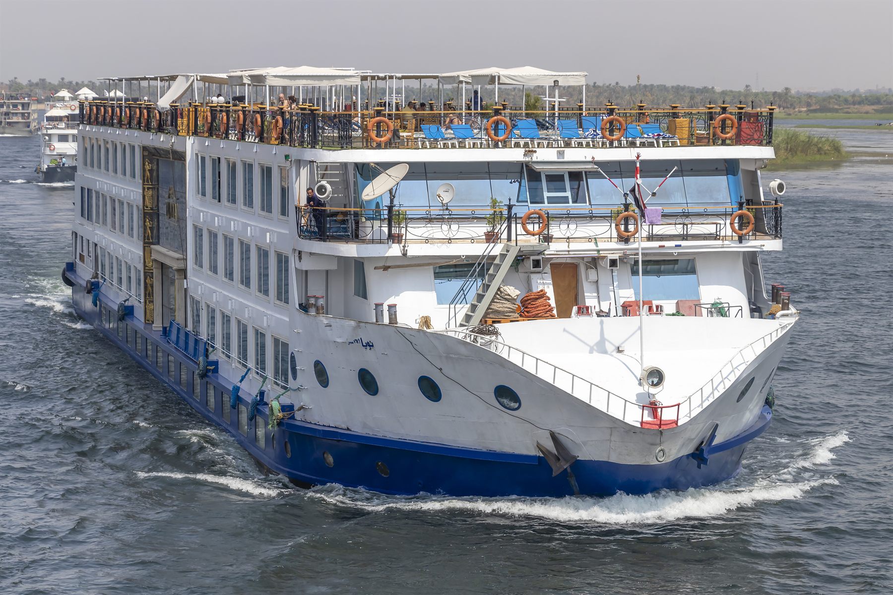 Multi-deck Nile cruise ship sailing toward the camera